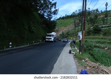 Wonosobo, Indonesia - July 4 2022 : Road Construction On A Slope Road. Man Directing Traffic On The Site