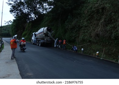 Wonosobo, Indonesia - July 4 2022 : Road Construction On A Slope Road. Man Directing Traffic On The Site