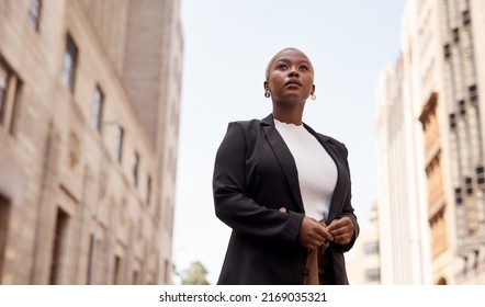 I wont stop till I realise my dream. Low angle shot of a young businesswoman looking thoughtful while standing in the city. - Shutterstock ID 2169035321