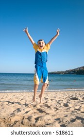 Woo Yay! Child Leaps Into The Air On The Beach