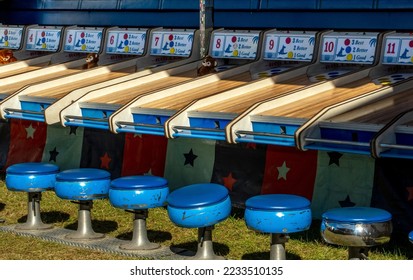 wood alleys and wooden balls rack up points for prizes in this fun game at a county fair and carnival - Shutterstock ID 2233510135