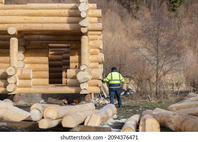 Wood Artist Worker Building Wood Cabin Or Mountain Chalet House. Wood Shortage And Wood Price Surge Affect The Wooden House Price. Construction Cottage From Wooden Beams. Log Home Lumber Construction