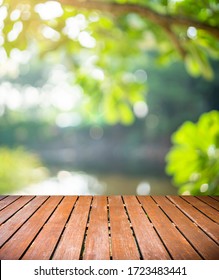 Wood Balcony Over Blur Nature View Of Green Leaf On Blurred Greenery Background In Garden