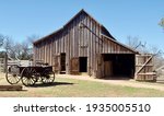 A wood barn and wagon at Lyndon B. Johnson State Park and Historic Site and the Sauer-Beckmann Farmstead, a living history farm in Stonewall, Texas. The farmhouse was built in the mid-1800s.