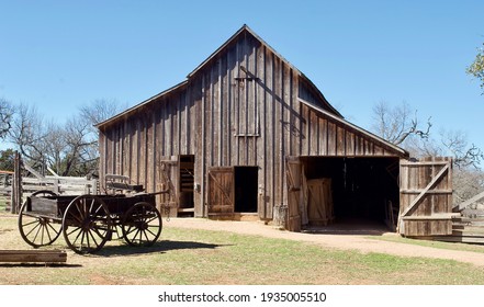 A wood barn and wagon at Lyndon B. Johnson State Park and Historic Site and the Sauer-Beckmann Farmstead, a living history farm in Stonewall, Texas. The farmhouse was built in the mid-1800s.