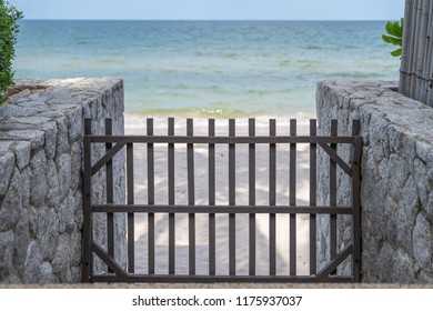 Wood Barricade And Barrier On The Stone Walkway To The Beach.