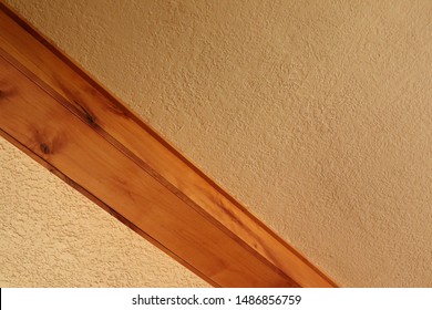 Wood beam against cream ceiling