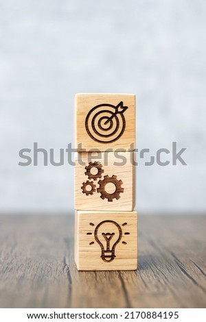 wood block with business goal, strategy, target, mission, action, objective, teamwork and idea concept
