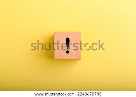 Wood block with exclamation mark concept on it.