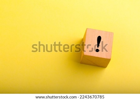 Wood block with exclamation mark concept on it.