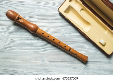 Wood Block Flute On White Wood Background