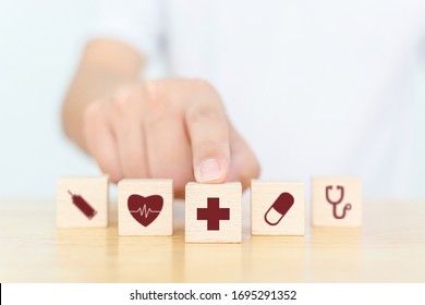 Wood block with icon healthcare medical, Insurance for your health concept