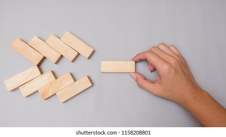 Wood block stacking arrow symbol with hand.Business concept on gray background - Shutterstock ID 1158208801