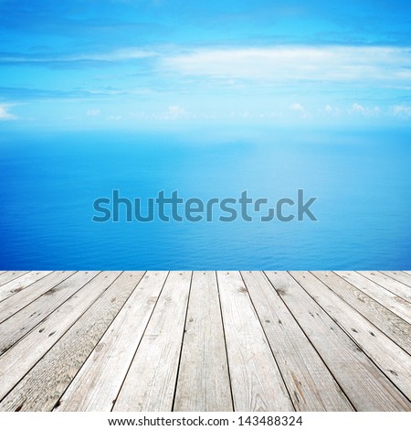 Wood, blue sea and sky background