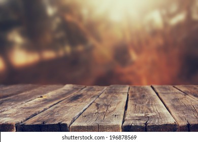 Wood Board Table In Front Of Summer Landscape With Lens Flare. 