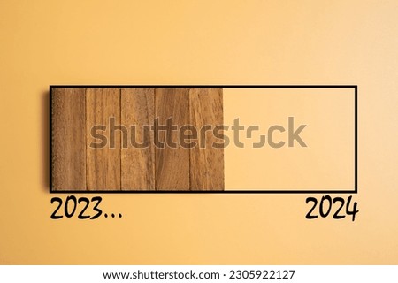 Wood brick as sign of developing progress from year 2023 going to new year 2024 with colored background. Count down to new year, half year business plan and strategy.