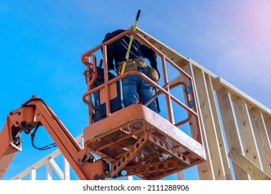 Wood building frame on new residential construction home framing home a boom truck forklift in the new home - Powered by Shutterstock