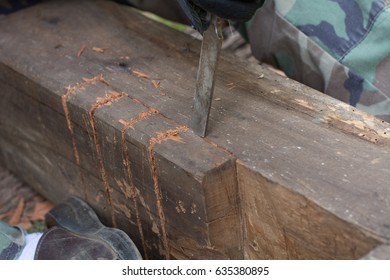 Wood carpenter with chisel
