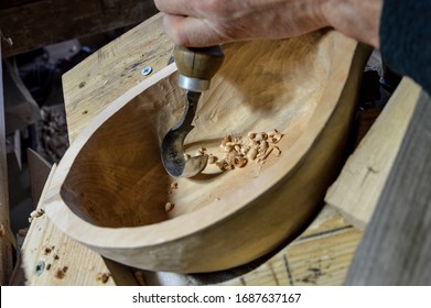 A wood Carver makes a wooden bowl. - Shutterstock ID 1687637167