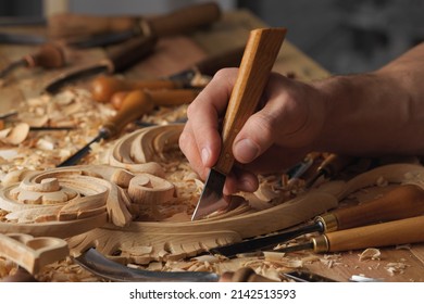 Wood Carving. Carpenter's Hands Use Chiesel. Senior Wood Carving Professional During Work. Man Working With Woodcarving Instruments