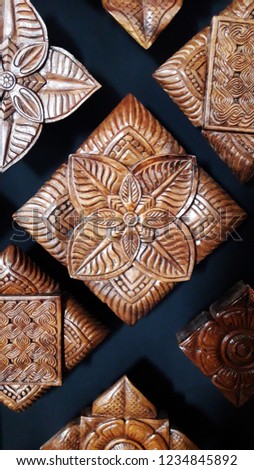 Wood carving with square pattern.