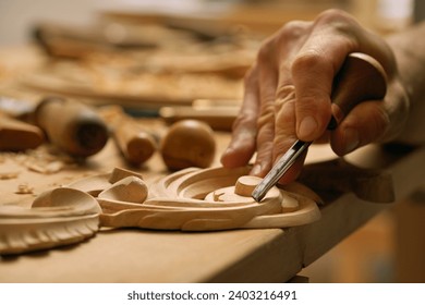 Wood carving tools. Carpenters hands use chisel. Senior wood carving professional during work. Man working with woodcarving instrument. - Powered by Shutterstock