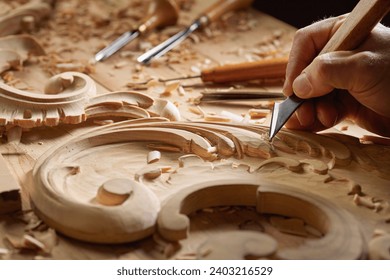 Wood carving tools. Carpenters hands use chisel. Senior wood carving professional during work. Man working with woodcarving instrument.