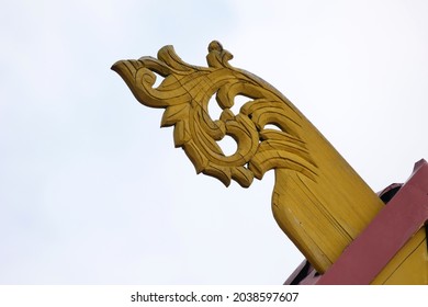 
Wood Carving With Yellow Paint On The Roof Of A Typical Malay