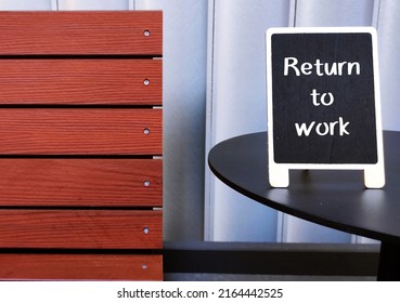 Wood Chair And Chalkboard With Handwritten Text RETURN TO WORK, Process Of Bringing Employees Back To Workforce Workplace After Absence Period Of Covid-19 Pandemic