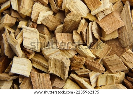 Wood chips for smocking texture background, top view. Natural apricot wood smoking chunks