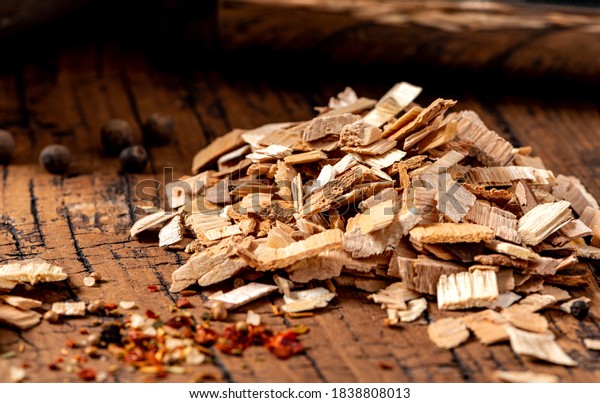 Wood chips for smoking meat or fish on an old\
wooden table close-up.