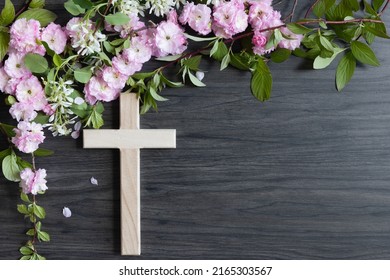 Wood Christian Cross And Border Of Branches With Spring Flower Blossoms On A Dark Wood Background With Copy Space