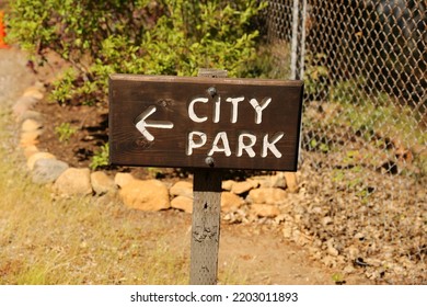 Wood City Park Entrance Sign. White Painted Letters And Dark Wood Stain.