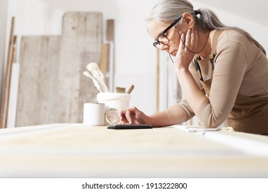 Wood Crafts, Woman Artisan Carpenter With Mobile Phone Search The Internet In Her Workshop, Restoration, Diy And Handmade Works Concept