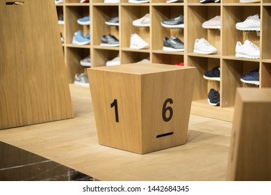 Wood cube with a 1 and 6 number, in background some sneakers.