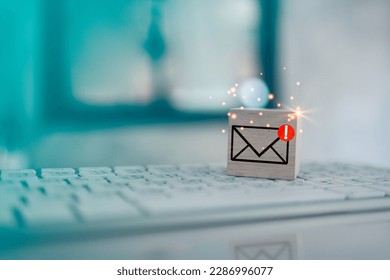 Wood cube block with envelope and notifications symbol icon for check e-mail on keyboard. Checking email. Direct marketing, online message, E-mail, electronic mail,communication concept.