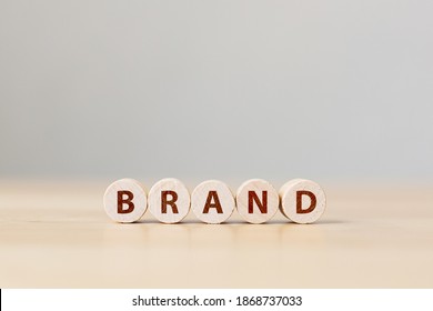 Wood Cube Block With Word BRAND On Wooden Table. Brand Building For Success Concept