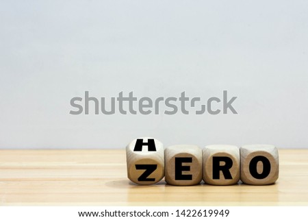 Wood cube zero or hero on wooden table wooden white background. 
Concept winner and loser effect.