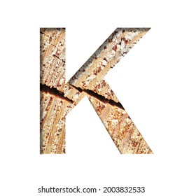 Wood Cut Font. The Letter K Cut Out Of Paper On The Background Of A Cut Of A Tree With Cracks And Shavings. Set Of Decorative Natural Alphabet Fonts.