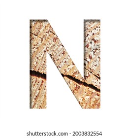 Wood Cut Font. The Letter N Cut Out Of Paper On The Background Of A Cut Of A Tree With Cracks And Shavings. Set Of Decorative Natural Alphabet Fonts.