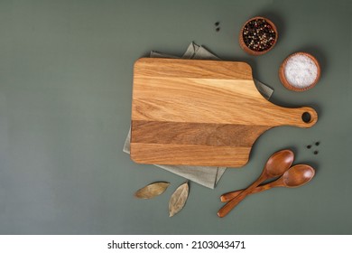 Wood cutting board and napkin on wooden table and spice, pepper, salt. Cooking food background for menu in rustic design. Top view