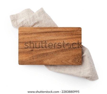 Wood cutting board on linen napkin isolated on white background, top view
