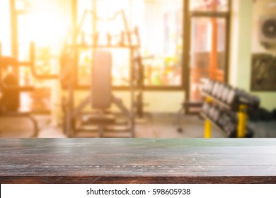 Wood Desk And Gym On Background.