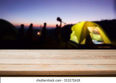 wood desk and night camping background. - Shutterstock ID 313172618