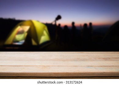 wood desk and night camping background. - Shutterstock ID 313172624