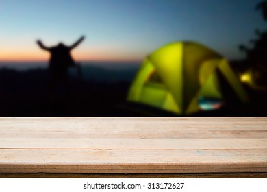 wood desk and night camping background. - Shutterstock ID 313172627
