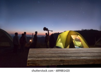 Wood desk on camping at night time with present product Backpacking. - Shutterstock ID 689881420