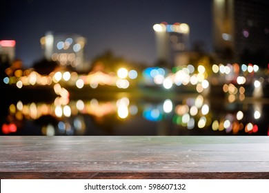 Wood Desk For Present Product And Blur Bokeh Night City On Background.