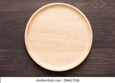 Wood Dish On The Wooden Background. Top View.