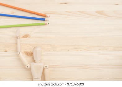 Wood doll on wooden background. Concept of art supplies, creativity and education. - Powered by Shutterstock